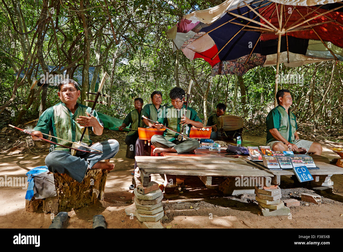 Group of victims of land mines plays traditional Khmer music near Ta Prohm temple. Angkor Archaeological Park, Siem Reap, Cambodia. Stock Photo