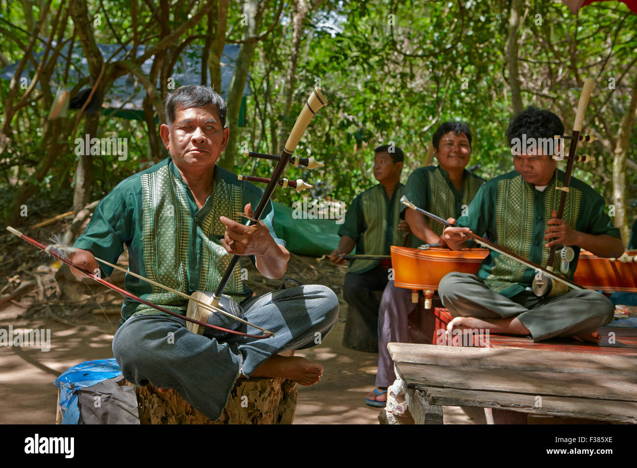 Group of victims of land mines playing traditional Khmer music near Ta Prohm temple. Angkor Archaeological Park, Siem Reap Province, Cambodia. Stock Photo