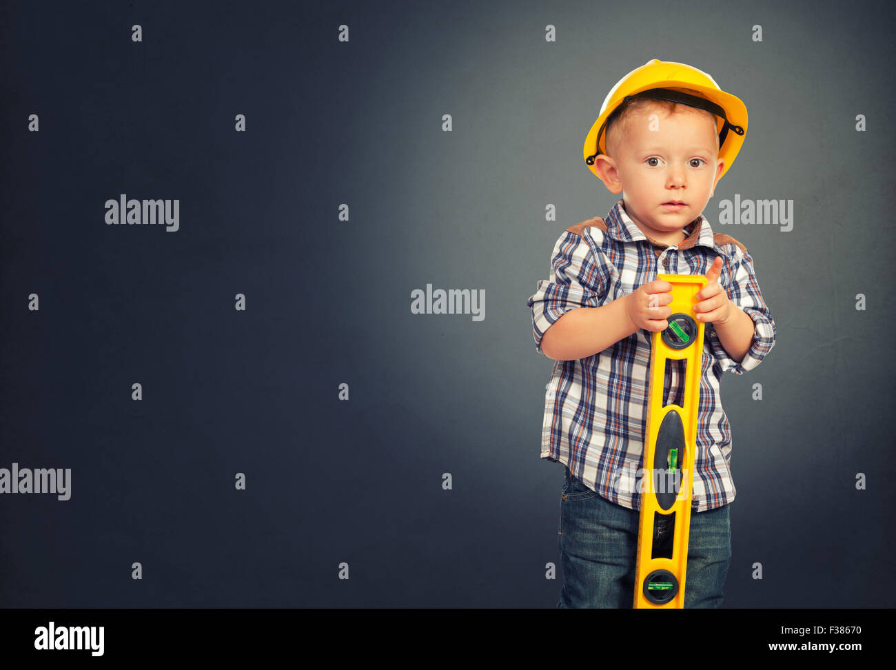 cute child act like handyman and gray grunge background Stock Photo