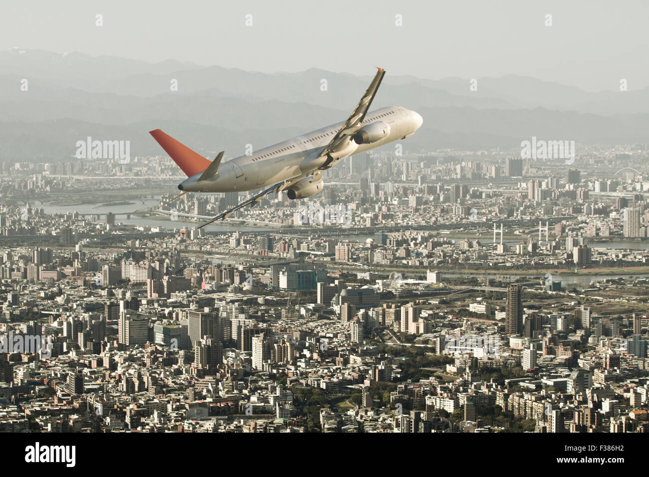 airplane fly through taipei city,Business Travel Stock Photo