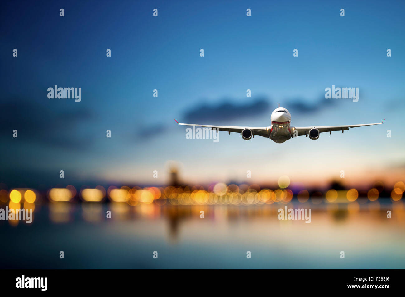 perspective view of jet airliner in flight with bokeh background Stock Photo