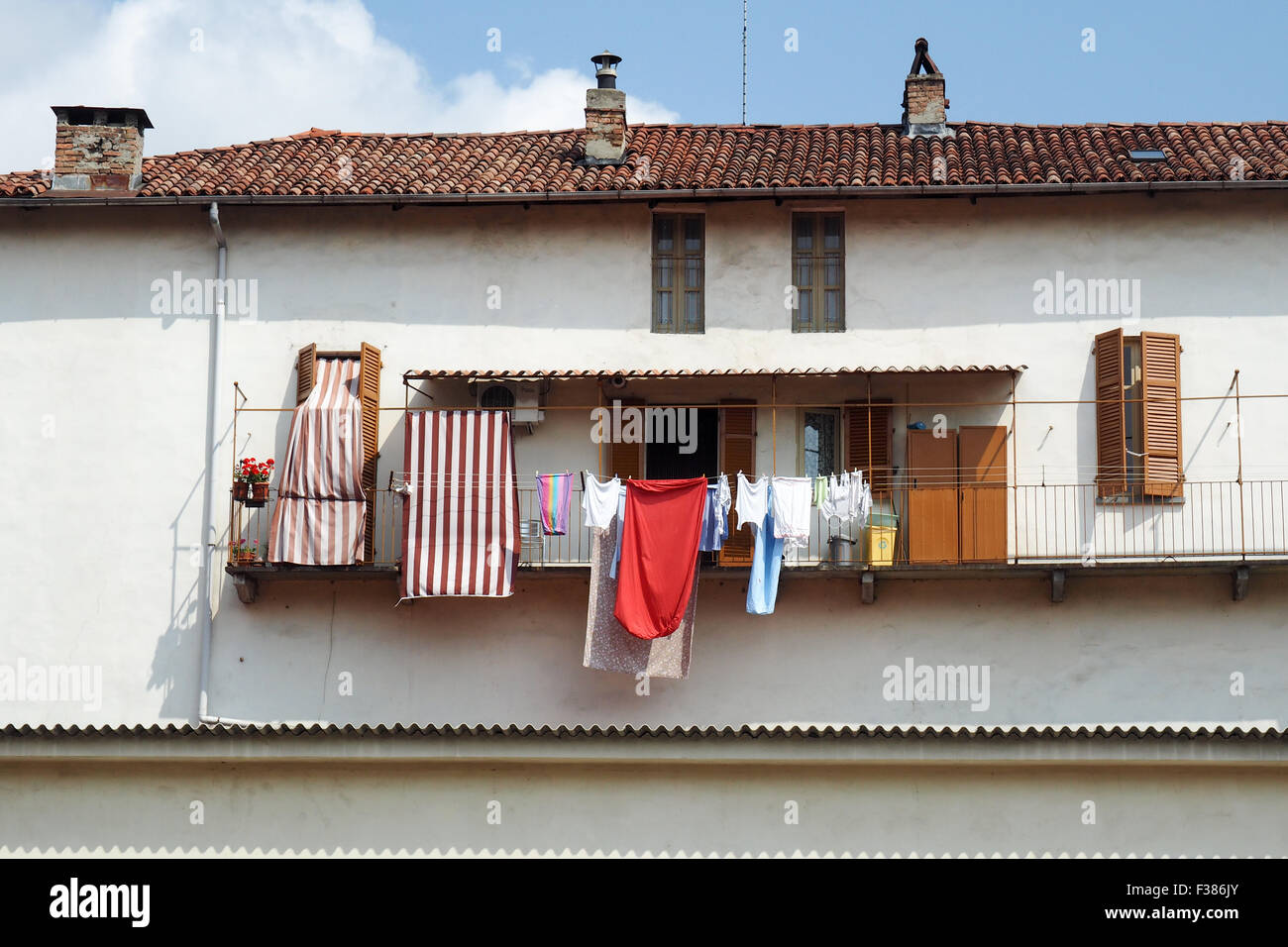 Laundry hanging out to dry on a balcony. Stock Photo