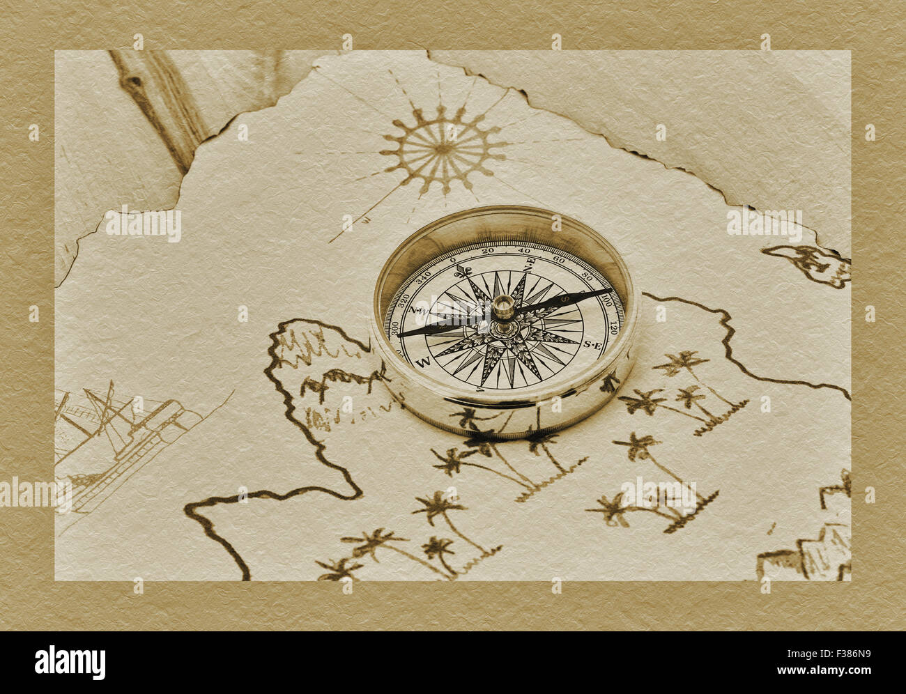 a compass lies on an old treasure map Stock Photo