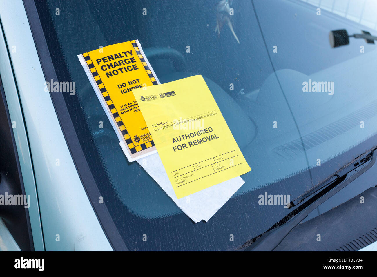 Parking ticket, UK. Penalty Charge notice with Authorised For Removal notice added and attached to a windscreen, Nottingham, England, UK Stock Photo