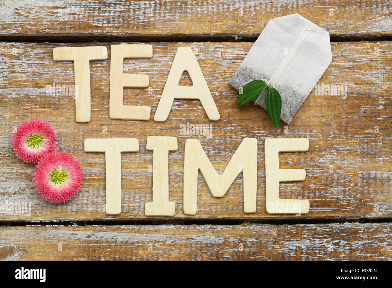 Tea time written with wooden letters on rustic surface Stock Photo
