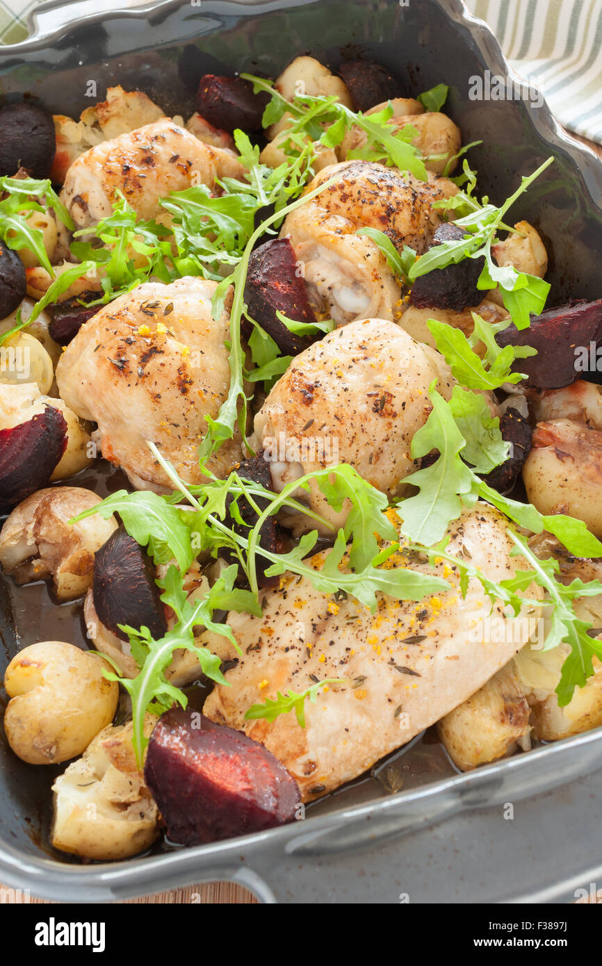 Roasted lemon and thyme chicken with garlic crushed new potatoes and beetroot in balsamic vinegar and olive oil Stock Photo