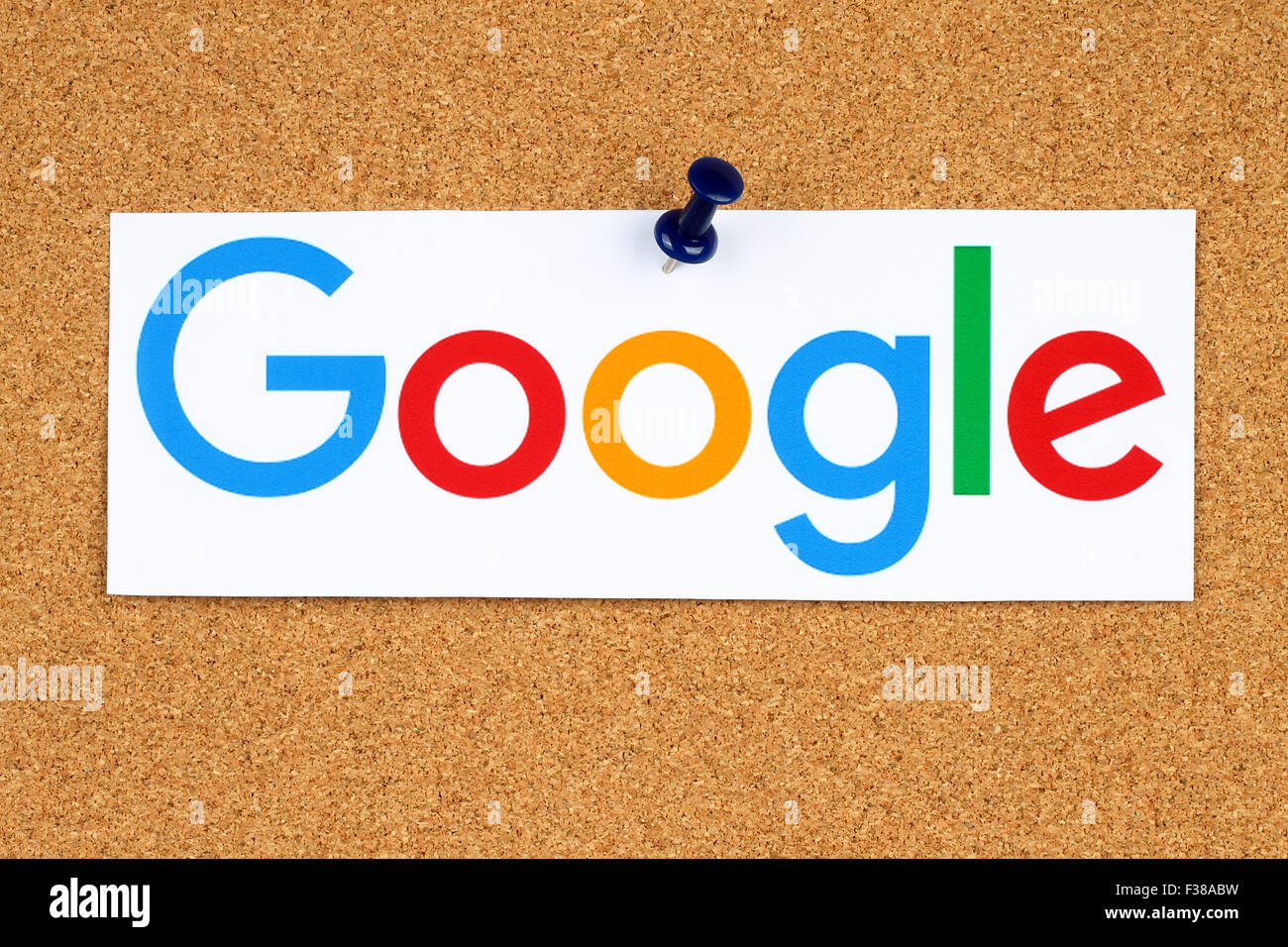 KIEV, UKRAINE - SEPTEMBER 02, 2015:New Google logotype printed on paper, cut and pinned on cork bulletin board Stock Photo