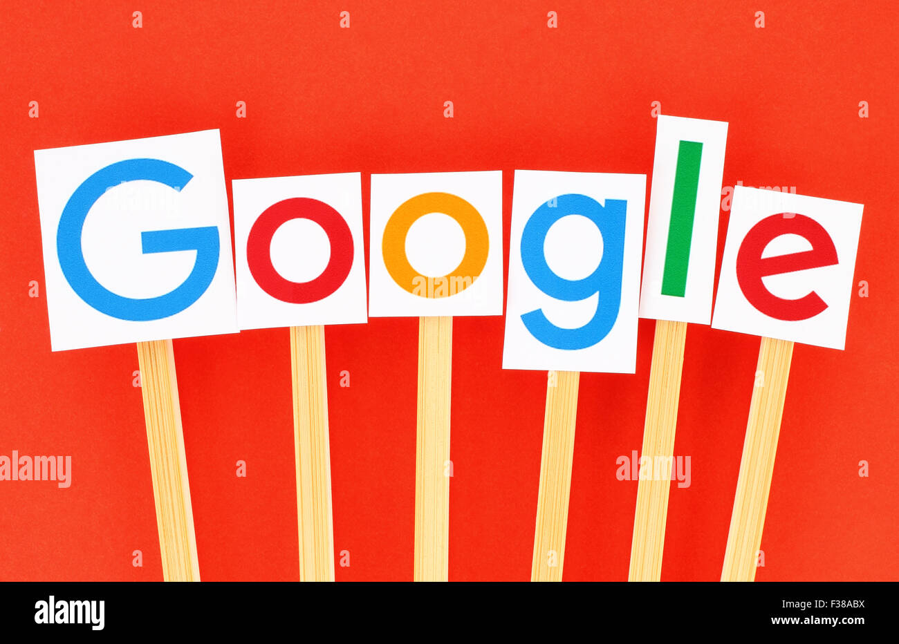 KIEV, UKRAINE - SEPTEMBER 02, 2015:New Google logotype printed on paper, cut and pasted on wooden sticks. Stock Photo