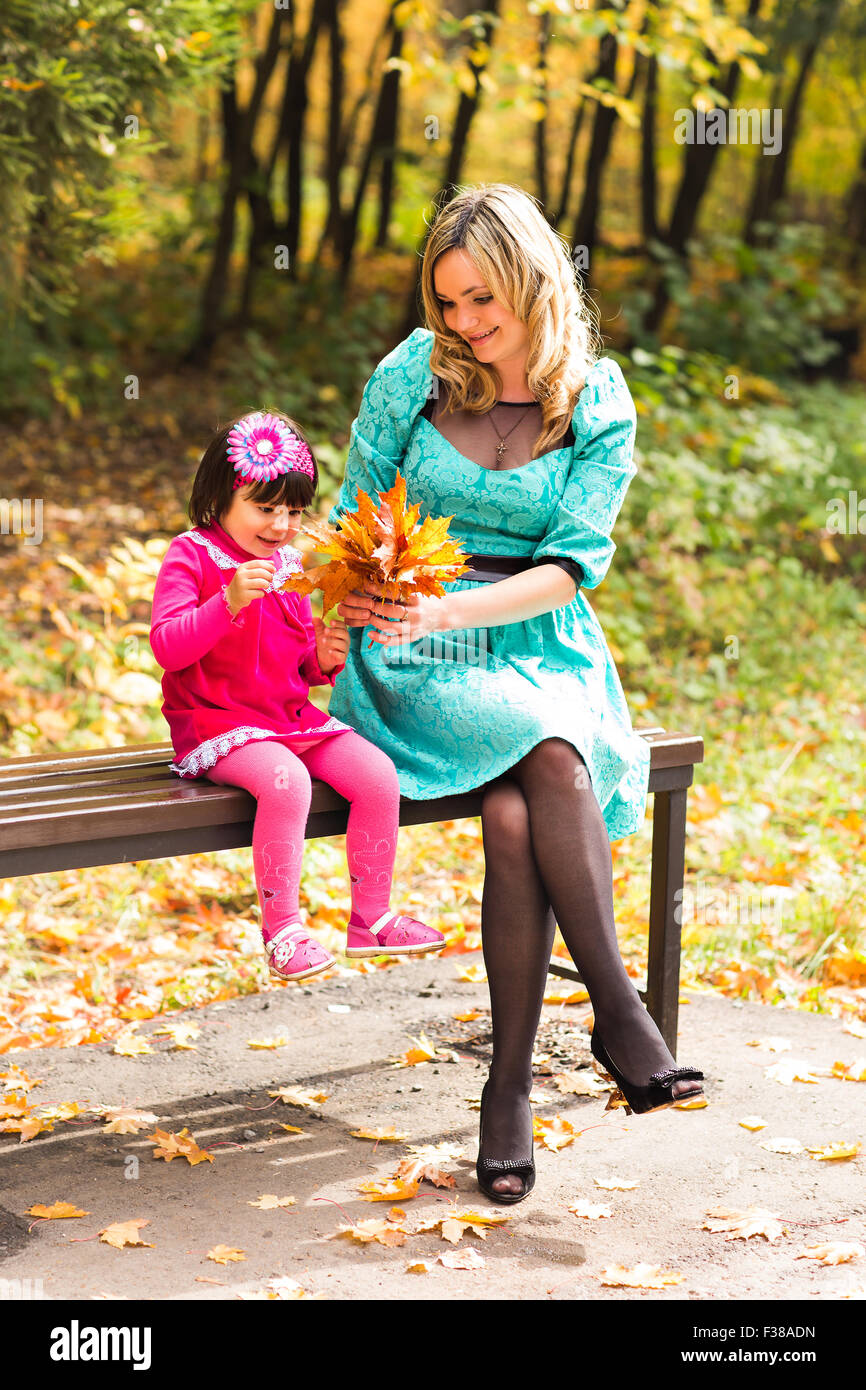 happy mother with her daughter for a walk in autumn park Stock Photo ...