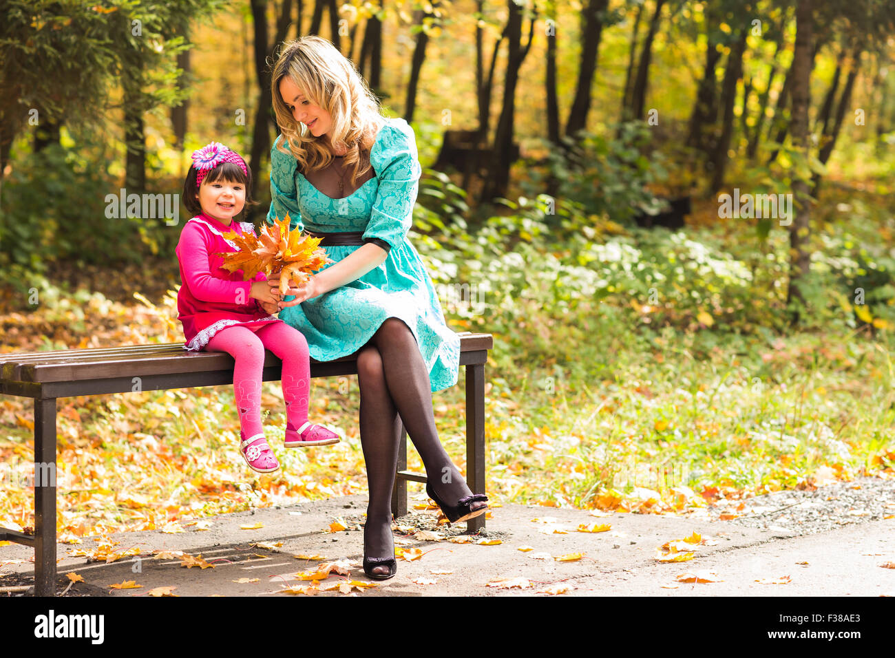 happy mother with her daughter for a walk in autumn park Stock Photo ...