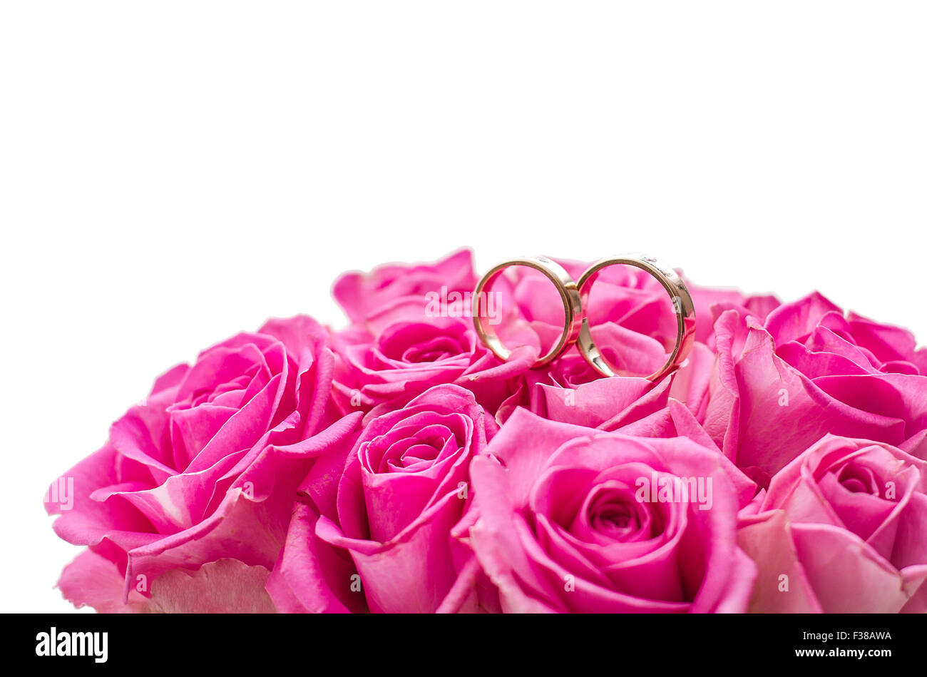 Two wedding rings on rose roses, top isolated Stock Photo