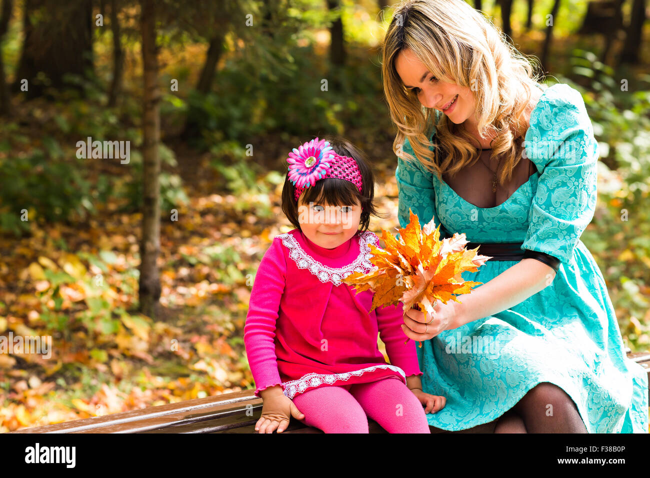 happy mother with her daughter for a walk in autumn park Stock Photo ...