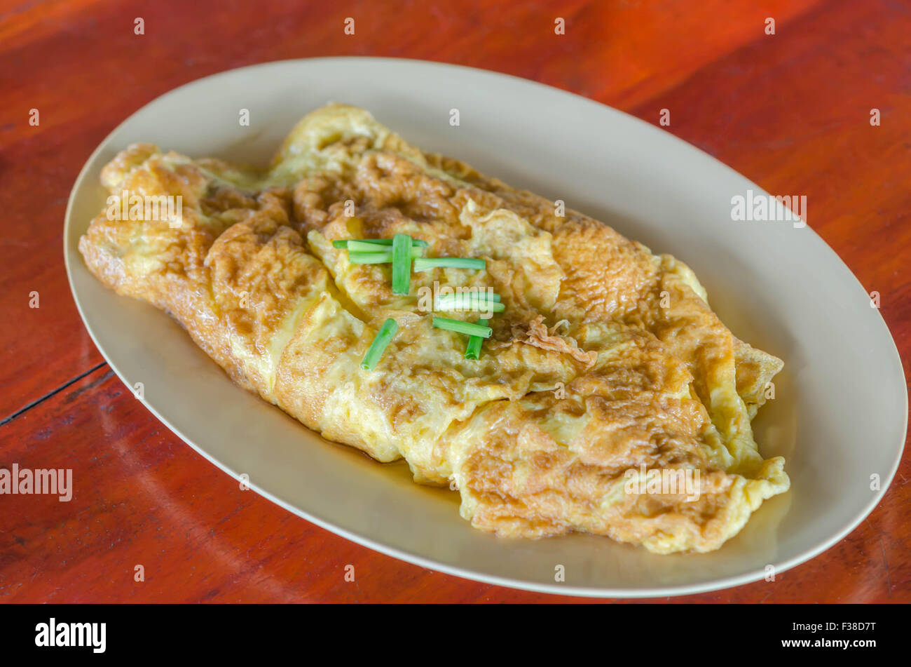 Thai omelette  or scrambled eggs with spring onion on dish Stock Photo
