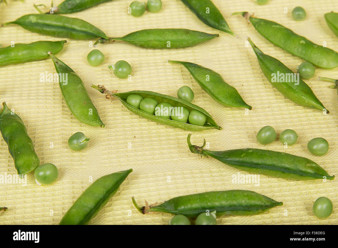 Fresh pea pods on a yellow background Stock Photo