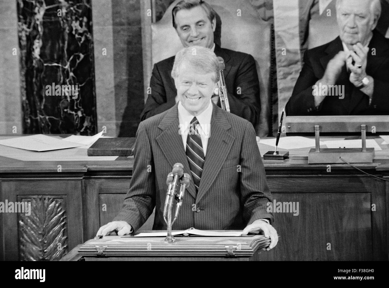 U.S. President Jimmy Carter smiles as he addresses a Joint Session of Congress announcing the success of the Camp David Accords as Vice President Walter Mondale and Speaker of the House Tip O'Neill watch from behind September 18, 1978 in Washington, DC. Stock Photo