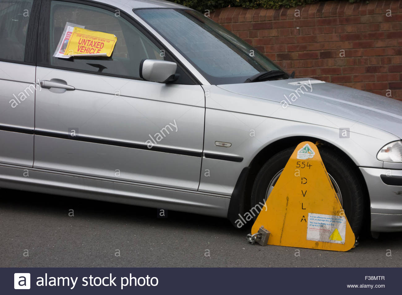 A DVLA wheel clamp on an untaxed vehicle on the streets of Sheffield