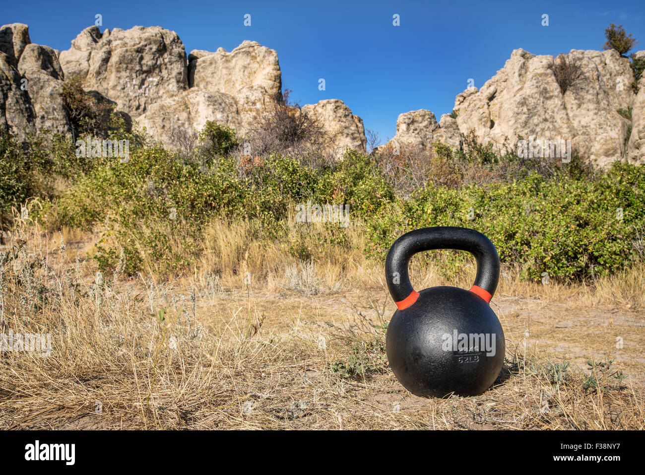 outdoor fitness concept - heavy iron kettlebell with rock formations in background Stock Photo
