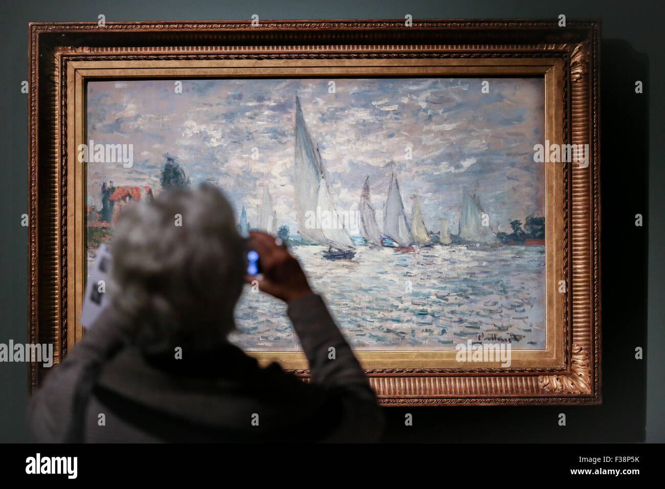 Turin, Italy. 01st Oct, 2015. A visitor take picture of the painting of Claude Monet. From 2 October to 31 January 2016 at the Gallery of Modern Art, the forty masterpieces, and including the five unreleased in Italy works of the French impressionist painter Claude Monet, who is considered the 'Father art Movement', will be exhibited. © Elena Aquila/Pacific Press/Alamy Live News Stock Photo