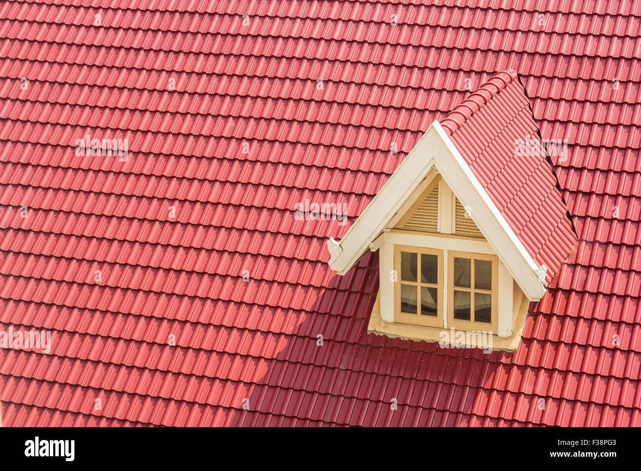 Dormer window on red roof Stock Photo
