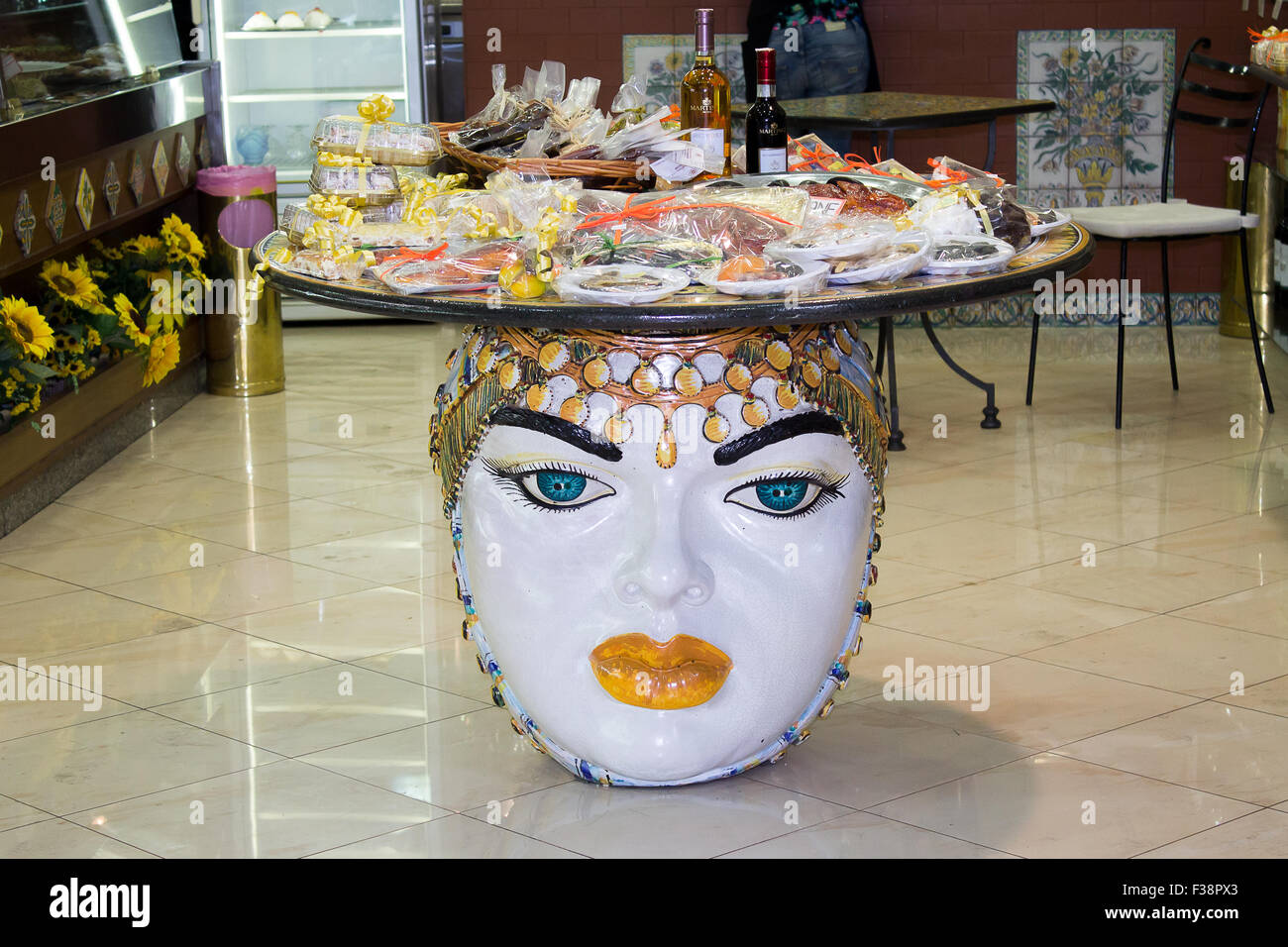 A shop table made from traditional Sicilian ceramics is on display to sell traditional souvenirs to tourists. Stock Photo