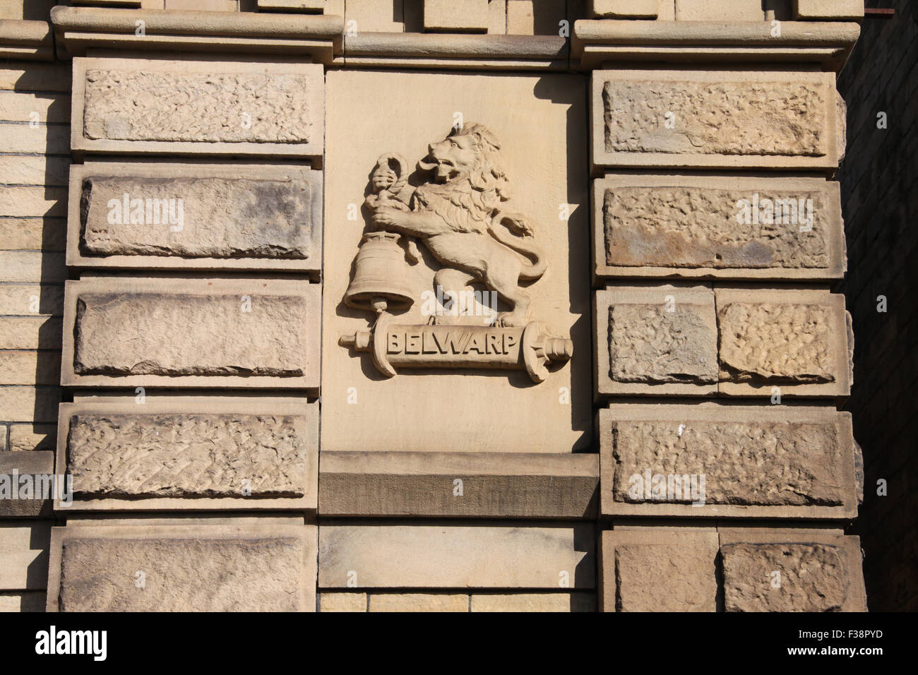 Belwarp logo of a lion and bell carved on the south face of Salts Mill in Bradford Stock Photo