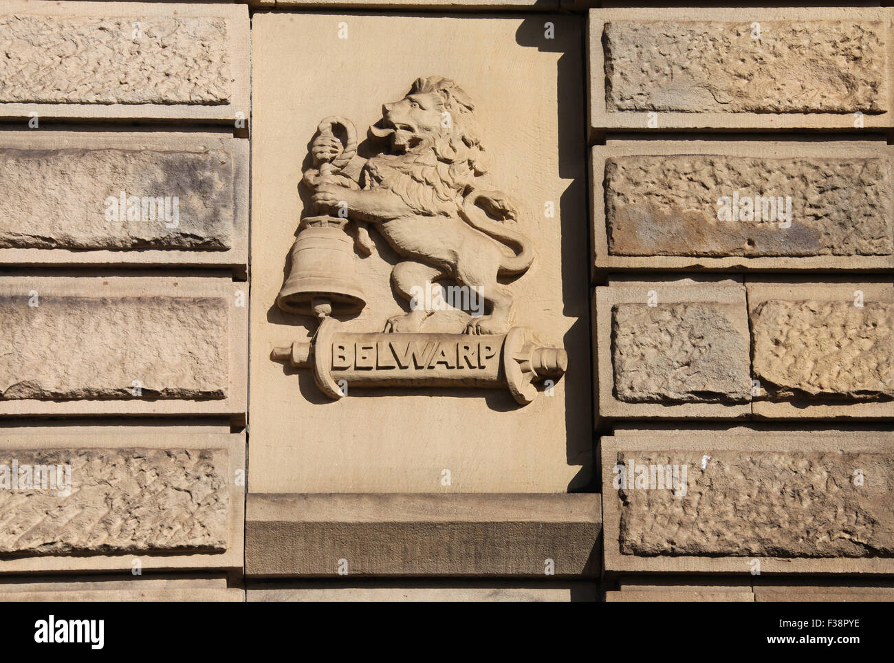 Belwarp logo of a lion and bell carved on the south face of Salts Mill in Bradford Stock Photo