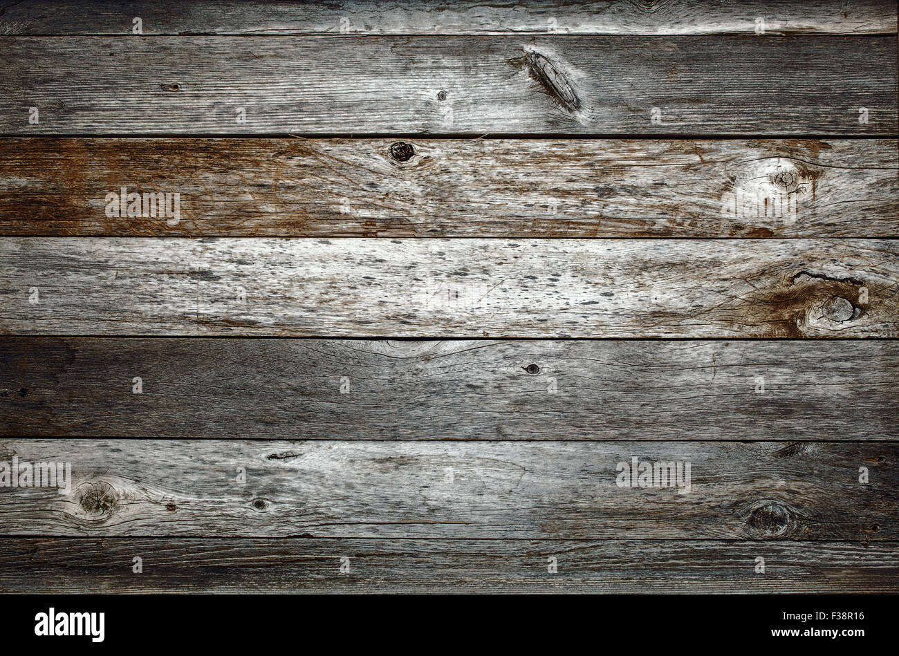 dark rustic weathered barn wood background with knots and nail holes Stock Photo