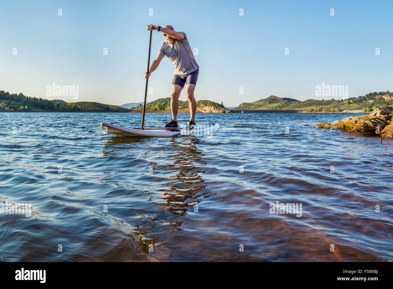stand up paddling workout on Horsetooth Reservoir at foothills of Rocky Mountains near Fort Collins, Colorado, summer scenery Stock Photo