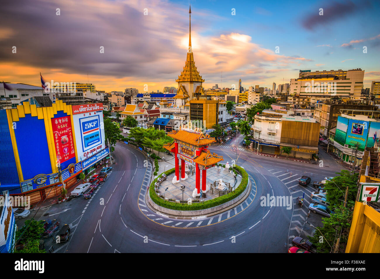 The Chinatown gate traffic circle with Wat Traimit behind in Bangkok, Thailand. Stock Photo