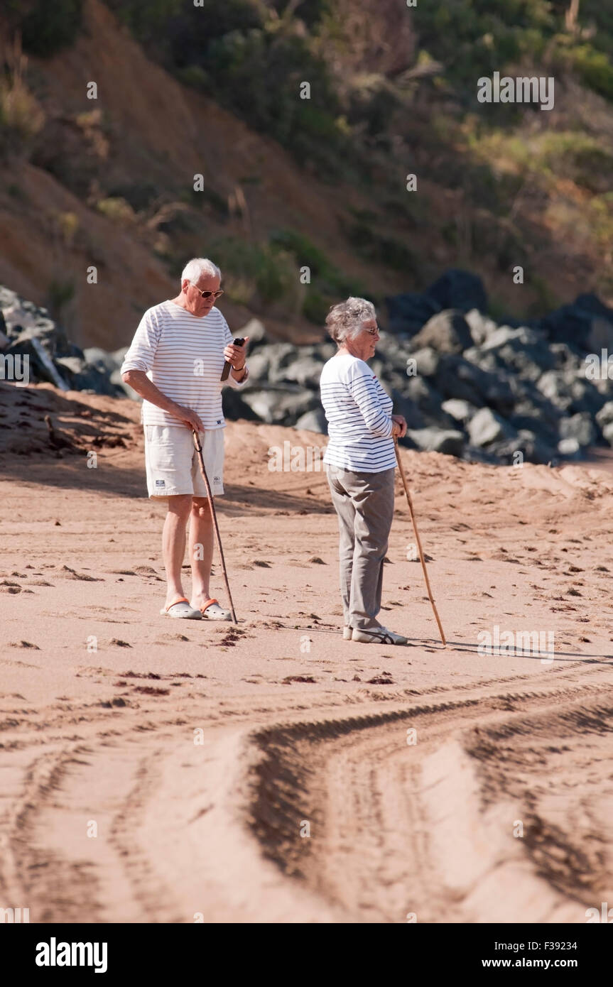 Senior couple walking on the beach Stock Photo - Alamy
