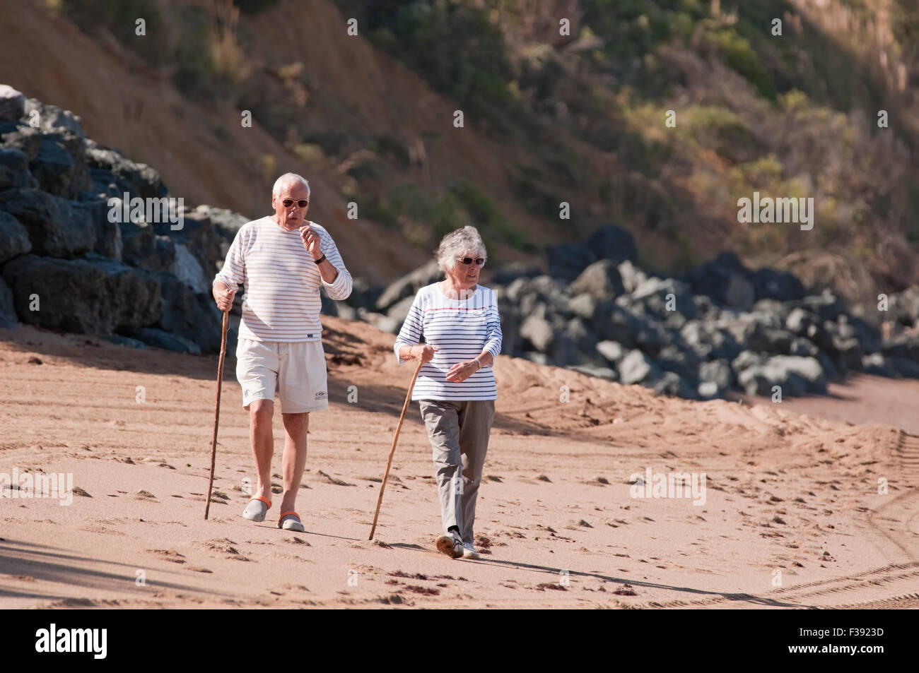 Senior couple walking on the beach Stock Photo - Alamy