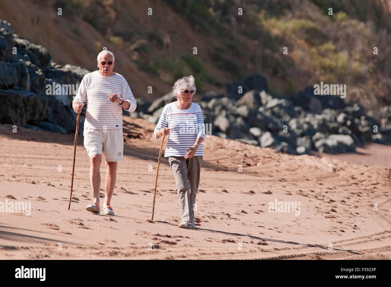 Senior couple walking on the beach Stock Photo - Alamy