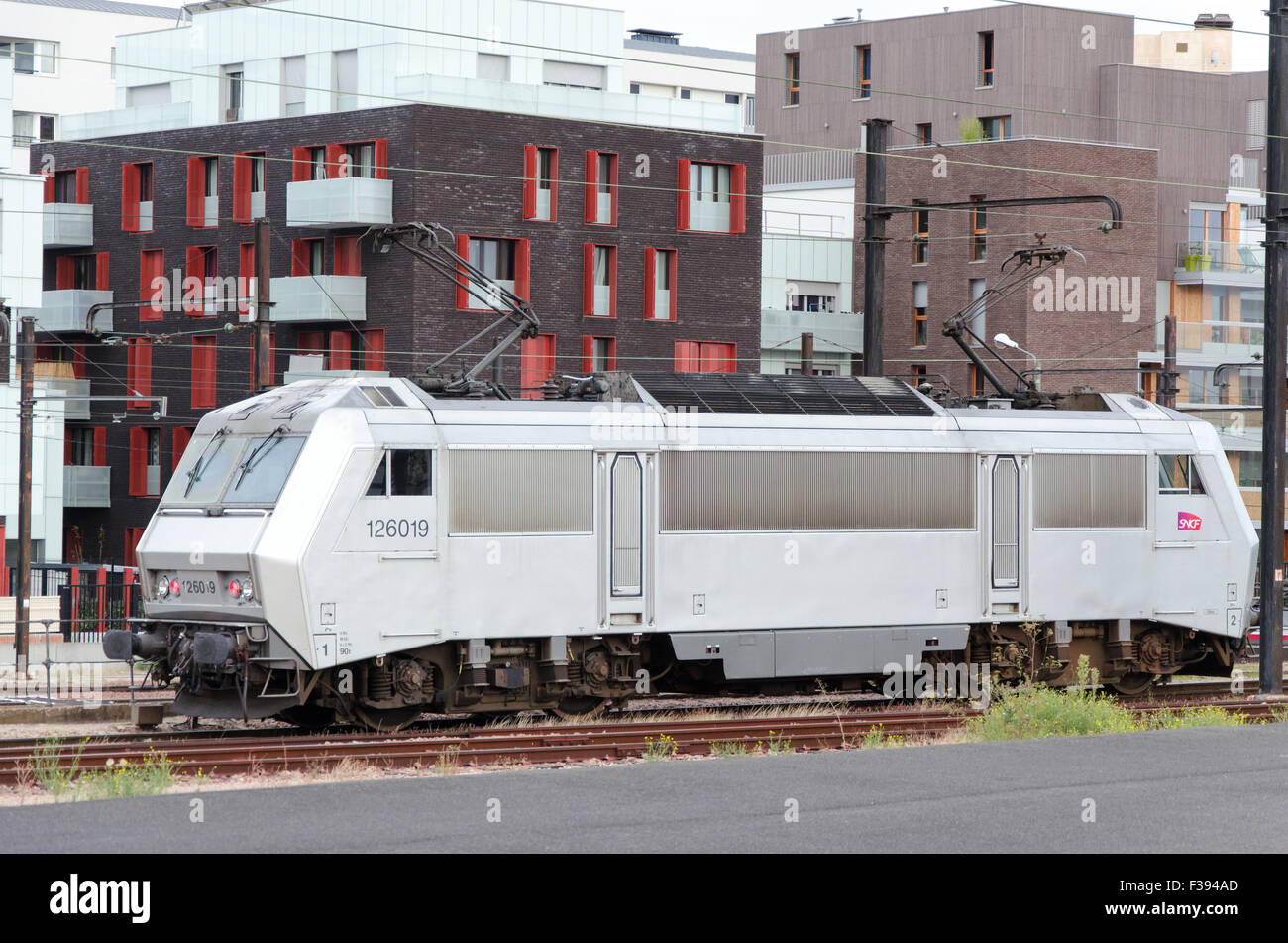 White vintage electrical train on an urban background at a railway station Stock Photo