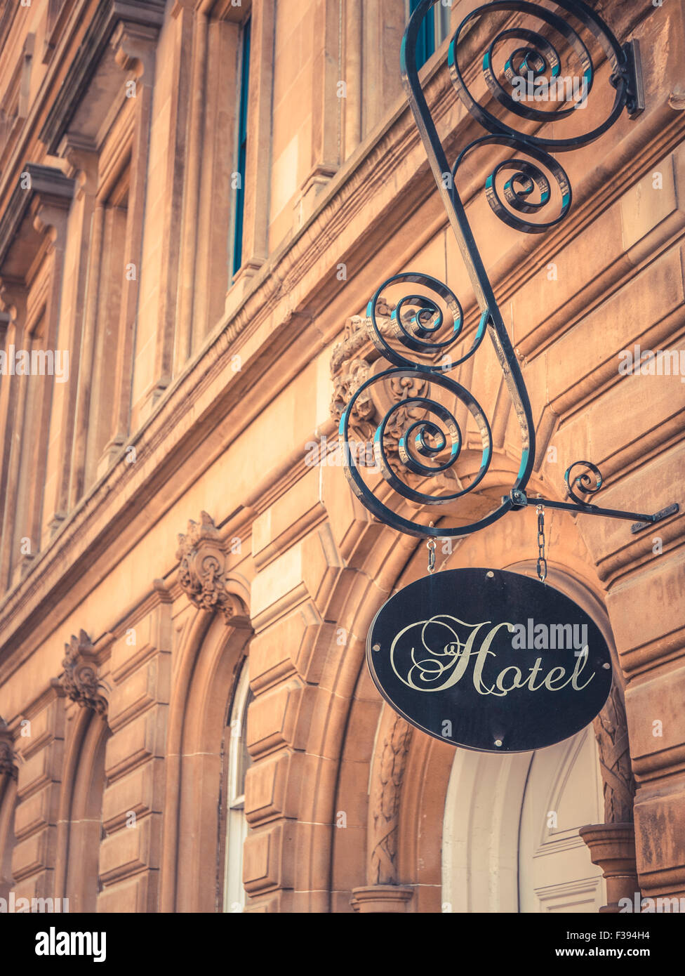 Ornate Sign For Luxury Hotel Outside Beautiful Sandstone Building Stock Photo