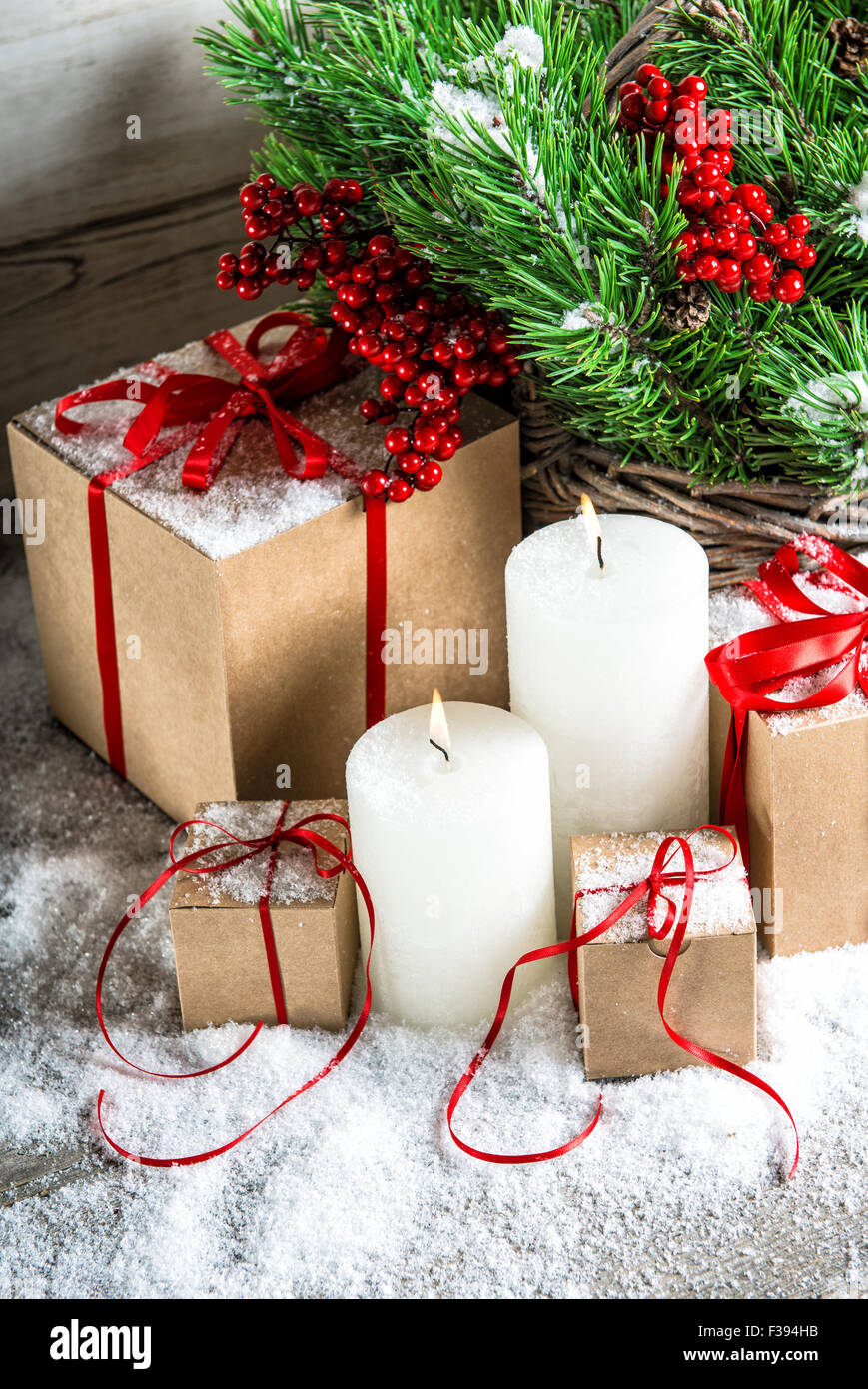 Christmas decoration with burning candles and gift box. Christmas tree branches Stock Photo