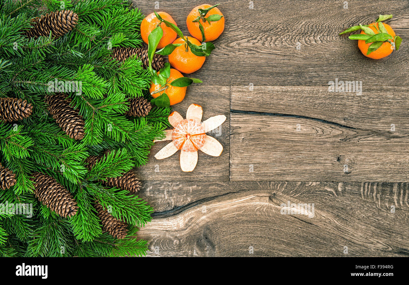 Mandarine fruits and christmas tree branches. Tangerine on wooden background Stock Photo
