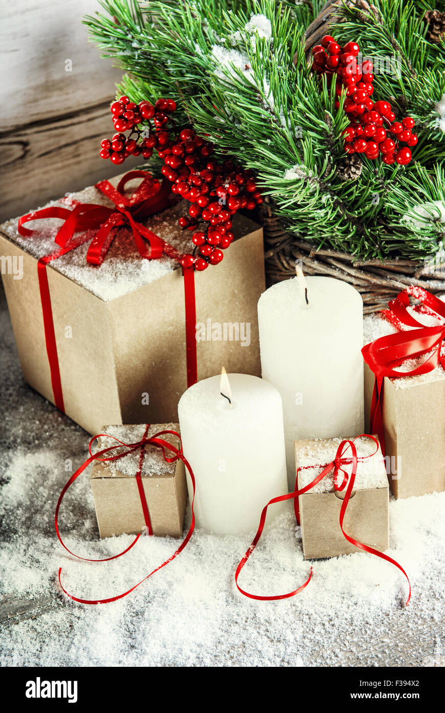 Christmas decoration with burning candles and gift box. Christmas tree branches Stock Photo