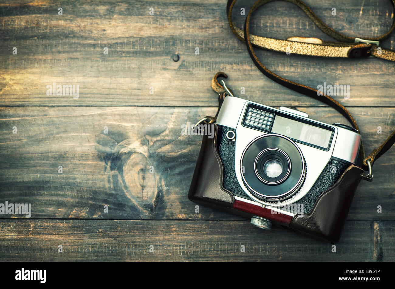 Retro camera on rustic wooden background. Vintage style toned ...