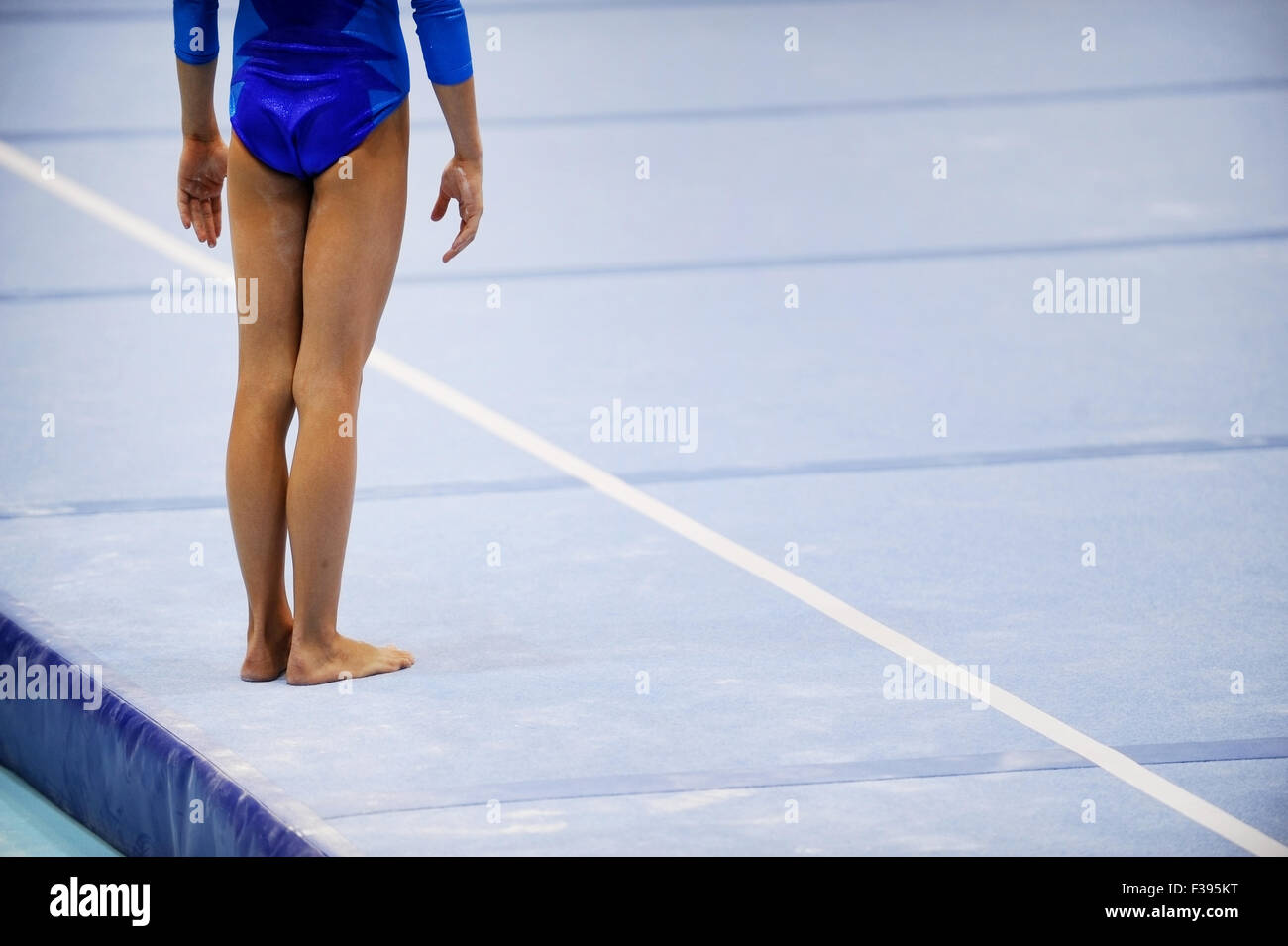 Feet of gymnast are seen on the floor exercise before gymnastics competition Stock Photo