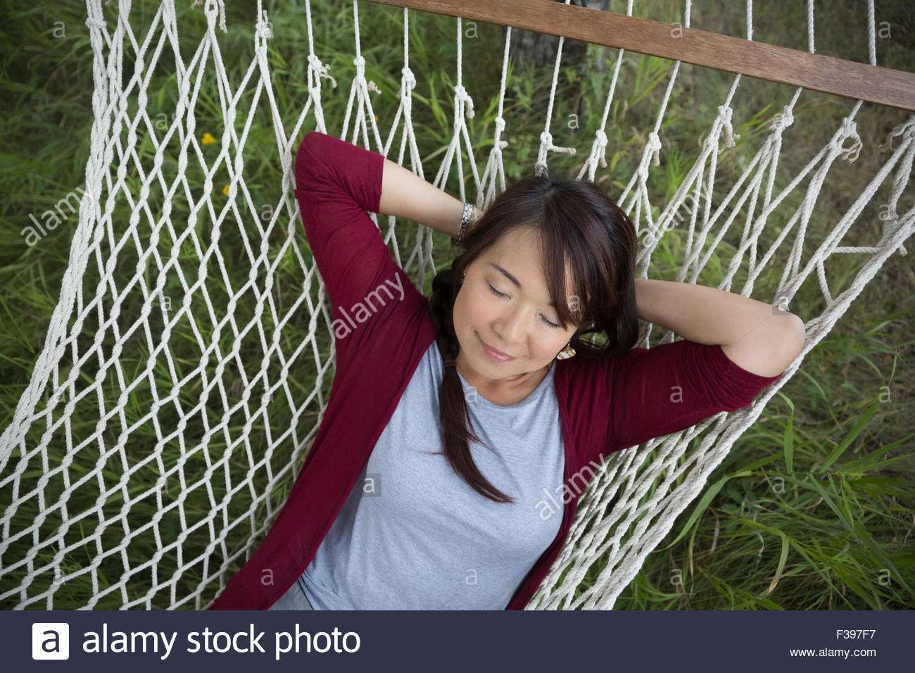 Serene woman napping on hammock Stock Photo