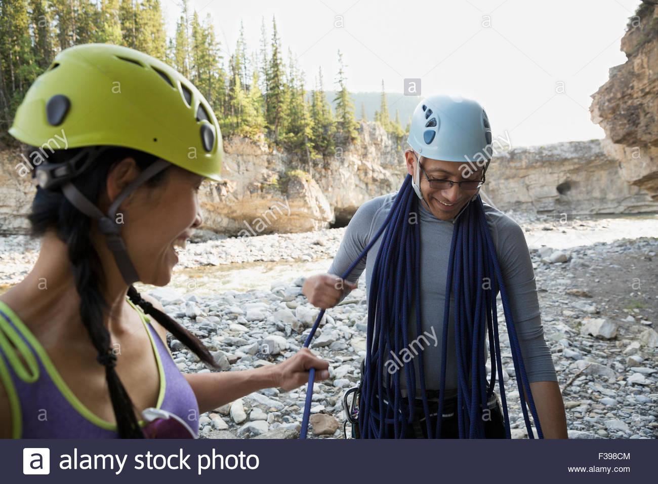 Friends with rock climbing rope and helmets Stock Photo