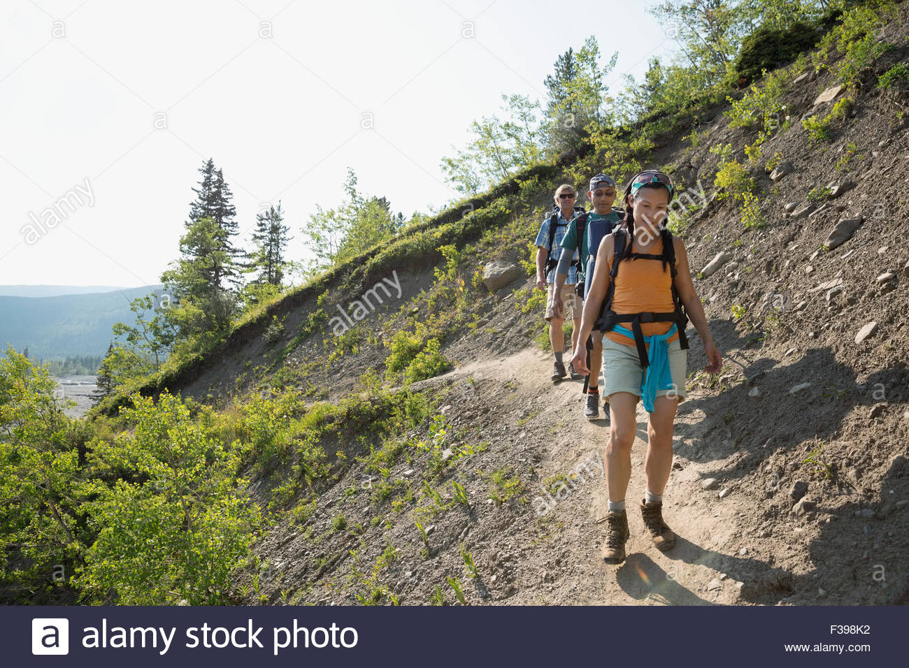 Friends hiking on craggy ridge trail Stock Photo