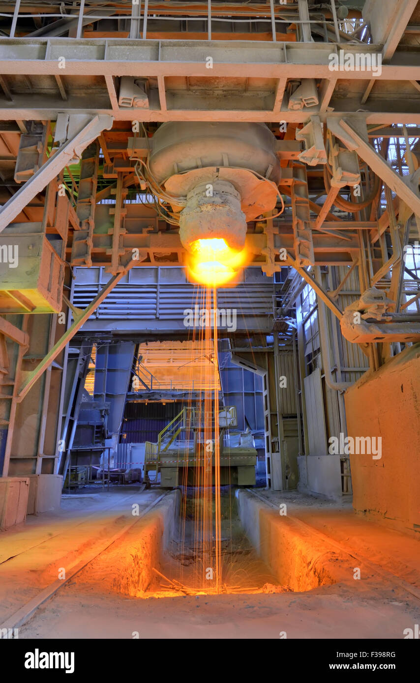 Pouring of liquid metal inside of steel plant Stock Photo