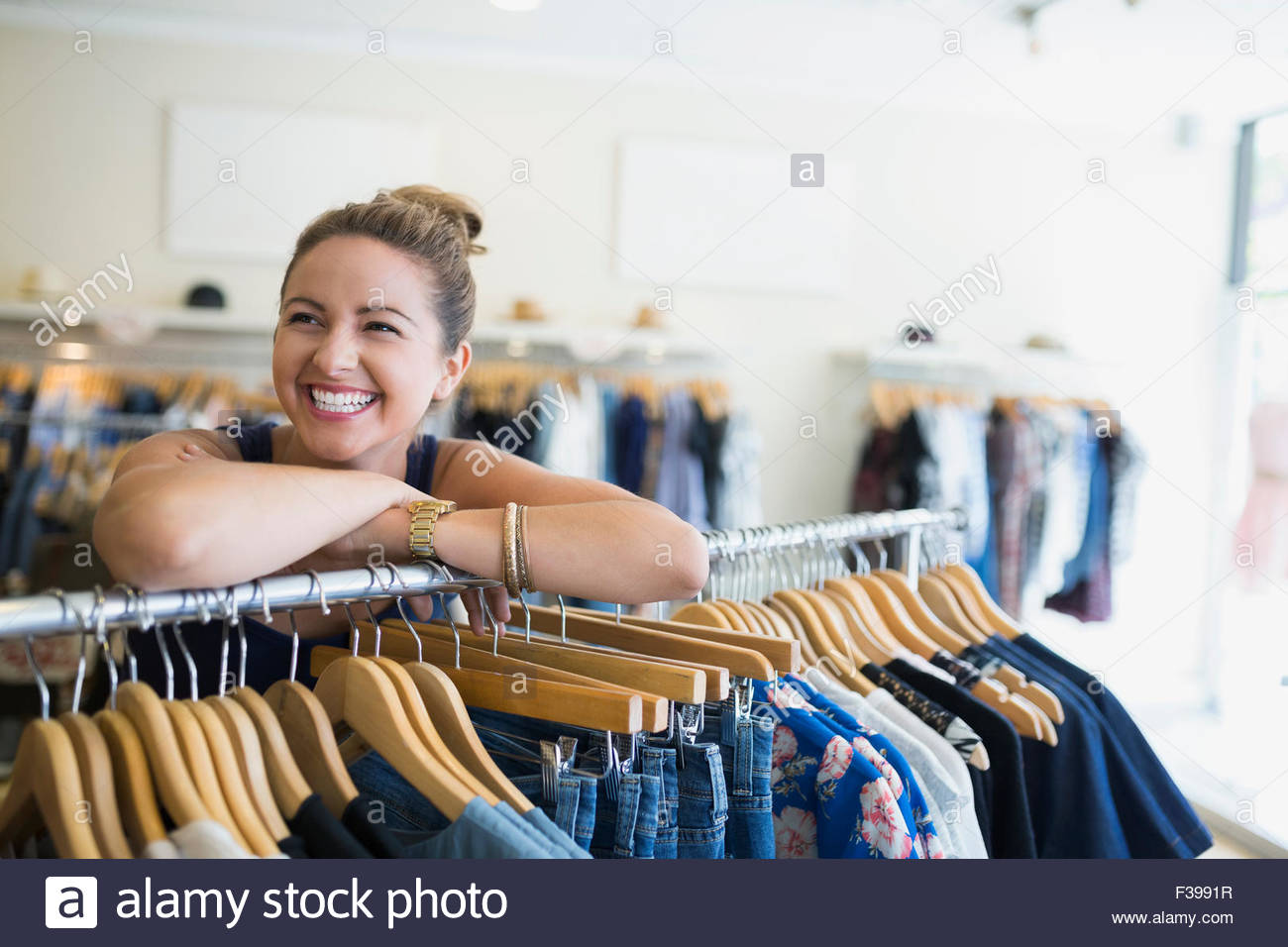 Portrait enthusiastic woman in clothing shop Stock Photo