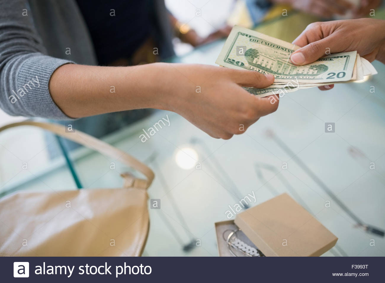 Woman paying cash at shop counter Stock Photo