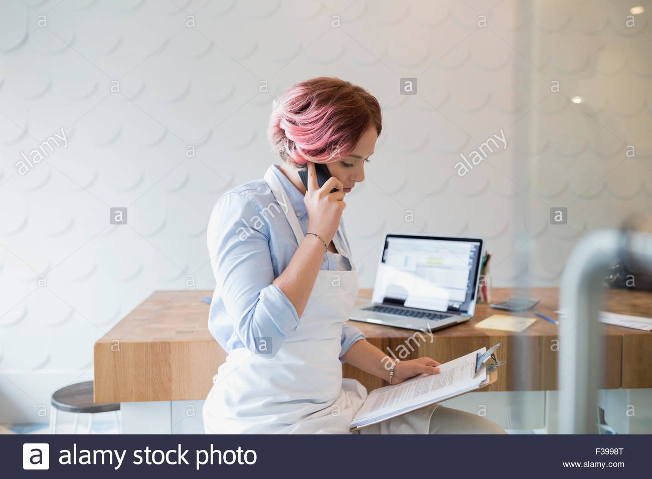 Bakery business owner with clipboard talking cell phone Stock Photo Alamy