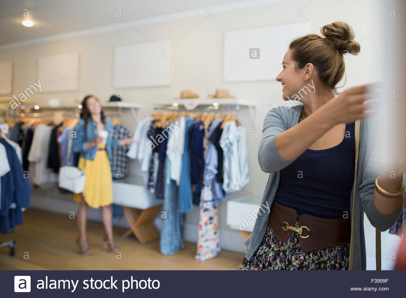 Woman browsing in clothing shop Stock Photo