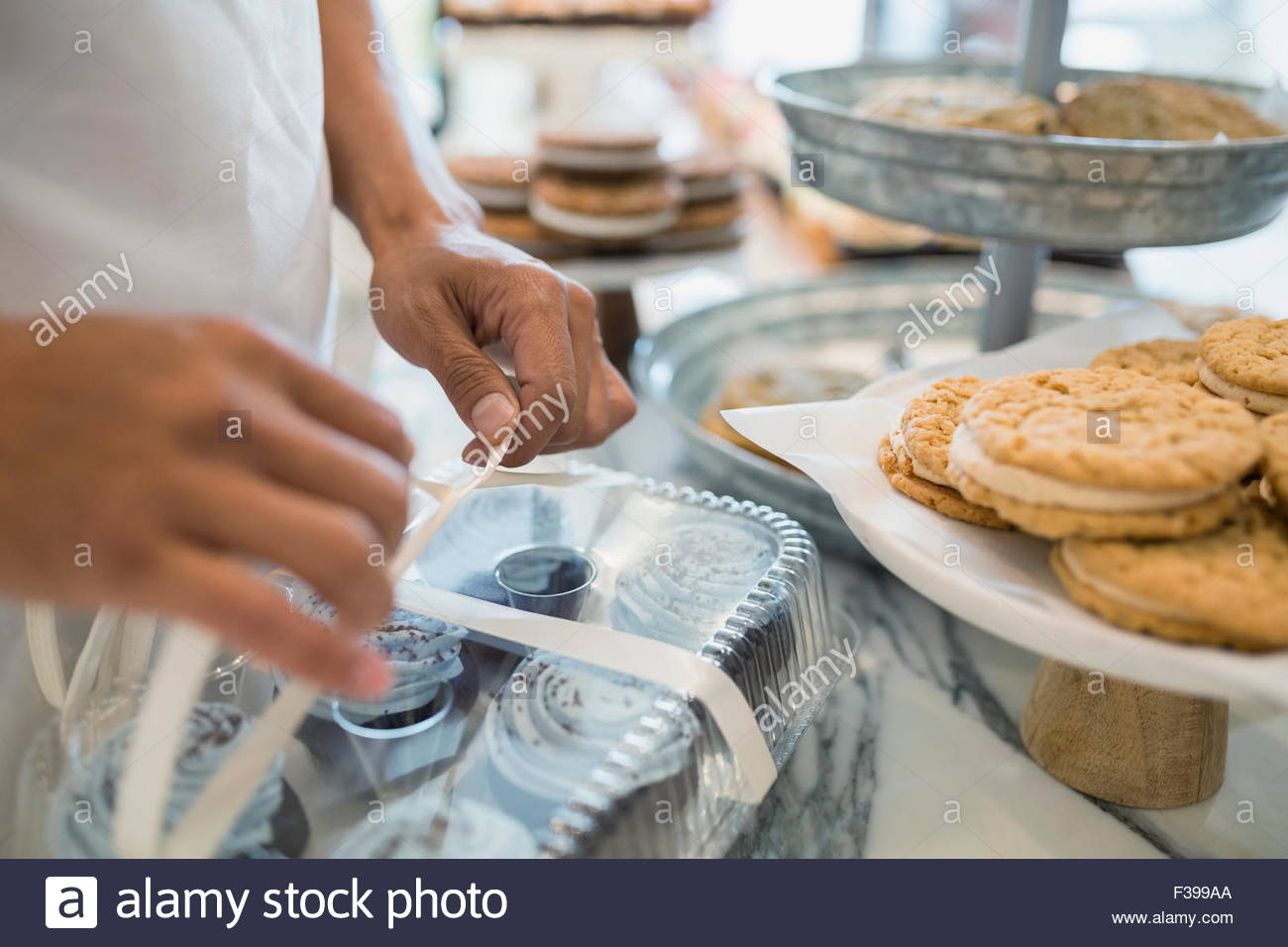 Close up worker tying box of pastries bakery Stock Photo Alamy