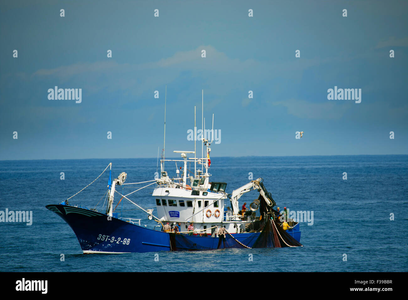 Fishing Boat collecting fishing nets, Cantabria, Spain Stock Photo Alamy