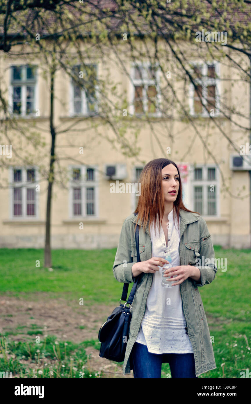 Portrait of a young woman on city street Stock Photo